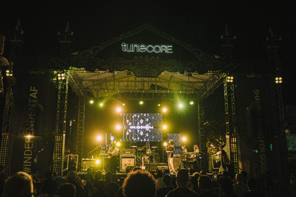 Night concert vibe at AXEAN Festival Jimbaran Hub Bali with lights, stage, and audience engagement