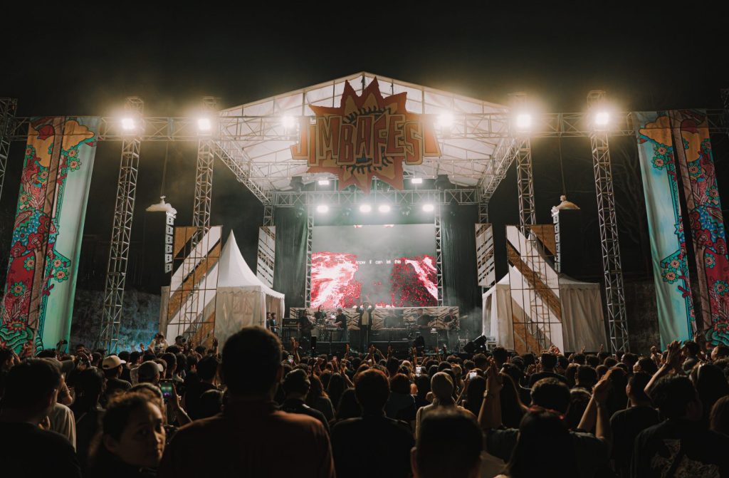 Indonesian musicians performing live on stage at JIMBAFEST Bali with audience under open sky